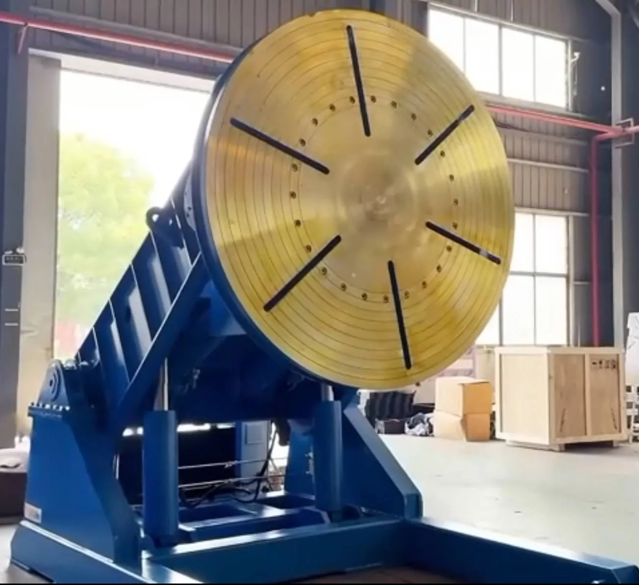 Large hydraulic welding positioner worktable seen from the side in the workshop